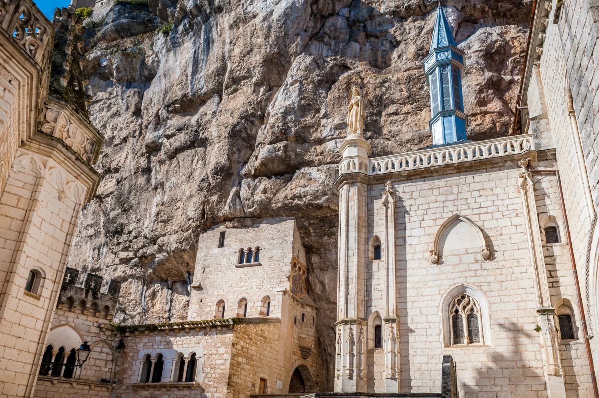 Sanctuary buildings built against a massive rock face, Rocamadour, France.