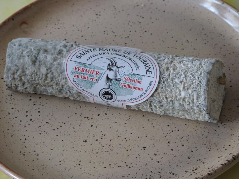 Sainte Maure de Touraine goat cheese log on speckled ceramic plate