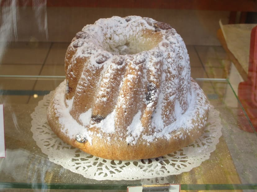 Kugelhupf cake dusted with powdered sugar on a paper doily